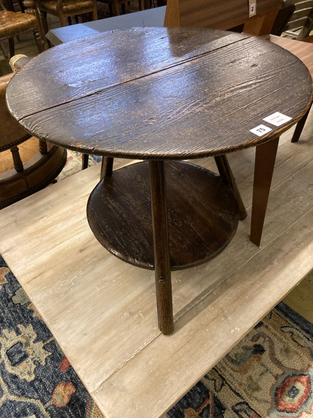 An 18th century pine cricket table, with undertier, 63cm diameter, height 56cm